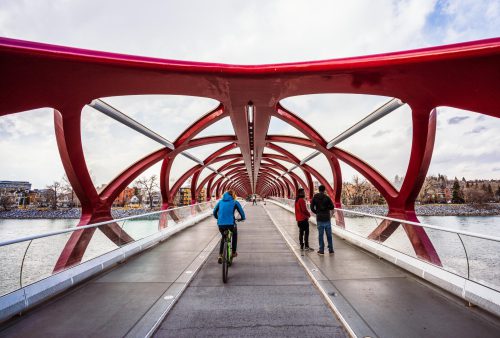 A cyclist on a red bridge